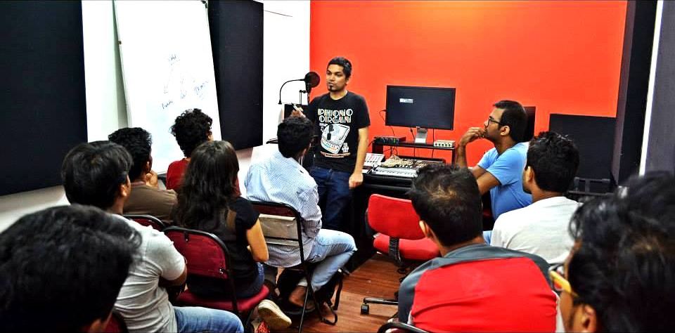 A full room of students facing the front during the Bharat Goel masterclass