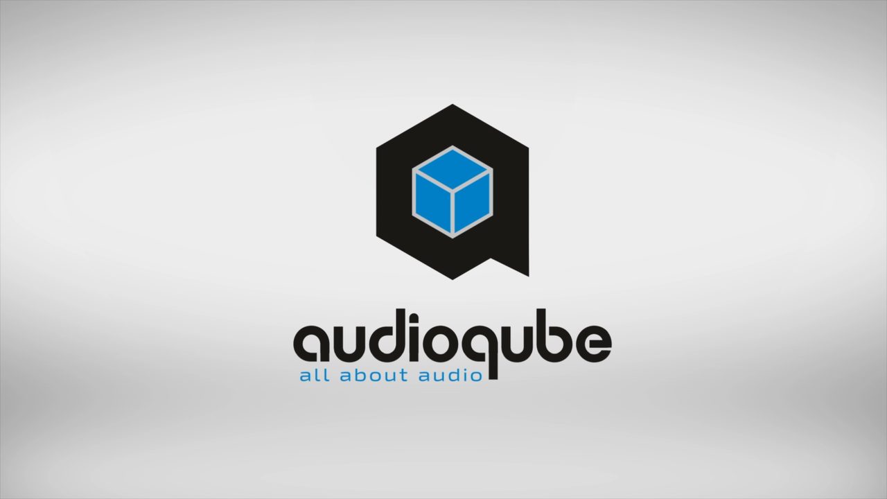 The Audioqube logo: a blue cube inside a black hexagon, above the audioqube wordmark and the line all about audio